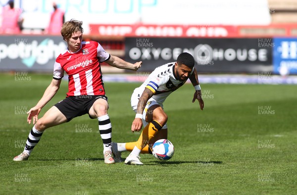 240421 - Exeter City v Newport County - Sky Bet League 2 - Joss Labadie of Newport County is tackled by Alex Hartridge of Exeter City