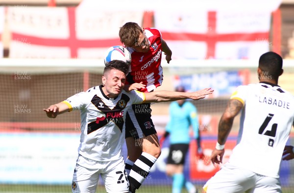 240421 - Exeter City v Newport County - Sky Bet League 2 - Anthony Hartington of Newport County is beaten in the air by Archie Collins of Exeter City