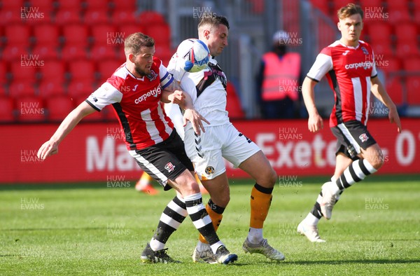 240421 - Exeter City v Newport County - Sky Bet League 2 - Anthony Hartigan of Newport County steals the ball from Pierce Sweeney of Exeter City