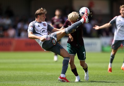 260725 - Exeter City v Swansea City - Pre Season Friendly - Jack Fitzwater of Exeter is challenged by Melker Widell of Swansea 