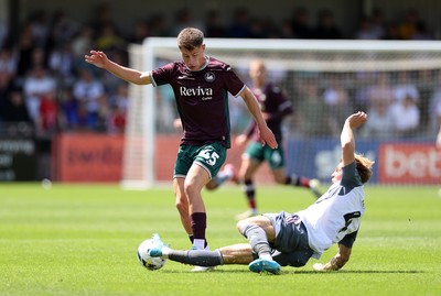 260725 - Exeter City v Swansea City - Pre Season Friendly - Cameron Congreve of Swansea is tackled by Ed Turns of Exeter 