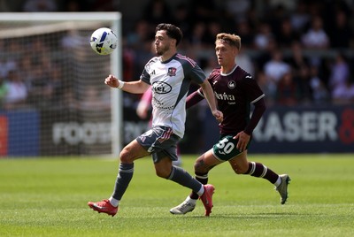 260725 - Exeter City v Swansea City - Pre Season Friendly - Jack Aitchison of Exeter is challenged by Ethan Galbraith of Swansea 