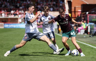 260725 - Exeter City v Swansea City - Pre Season Friendly - Cameron Congreve of Swansea is challenged by Charlie Cummins of Exeter 
