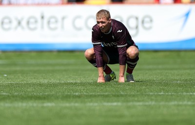 260725 - Exeter City v Swansea City - Pre Season Friendly - Dejected Jay Fulton of Swansea at full time