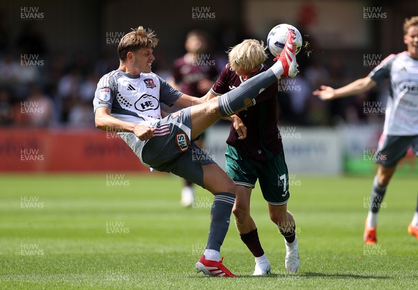 260725 - Exeter City v Swansea City - Pre Season Friendly - Jack Fitzwater of Exeter is challenged by Melker Widell of Swansea 