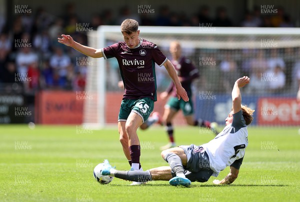 260725 - Exeter City v Swansea City - Pre Season Friendly - Cameron Congreve of Swansea is tackled by Ed Turns of Exeter 