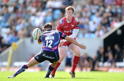 130816 - Exeter Chiefs v Scarlets - Preseason Friendly -Rhys Patchell of Scarlets is tackled by Tom Hendrickson of Exeter