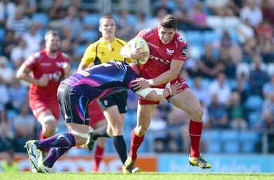 130816 - Exeter Chiefs v Scarlets - Preseason Friendly -Richard Smith of Scarlets is tackled by Moray Low