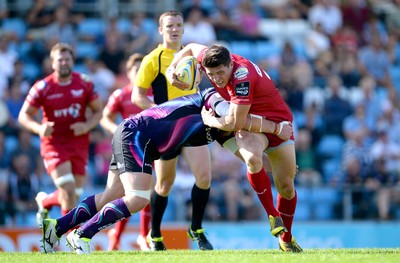 130816 - Exeter Chiefs v Scarlets - Preseason Friendly -Richard Smith of Scarlets is tackled by Moray Low