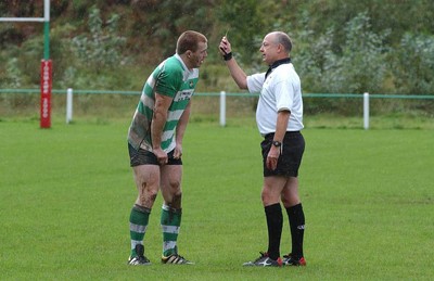 Collect pic  Spectator fights with rugby player. Mervyn Meredith is yellow carded by referee Michael Cox sparking violence from the touchline..   