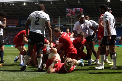 040726 - Fiji v Wales - Nations Championship - Jac Morgan of Wales is helped over by team mates to score a try 
