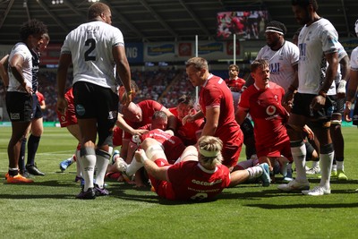 040726 - Fiji v Wales - Nations Championship - Jac Morgan of Wales is helped over by team mates to score a try 