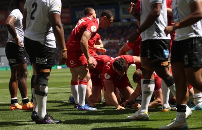040726 - Fiji v Wales - Nations Championship - Jac Morgan of Wales is helped over by team mates to score a try 