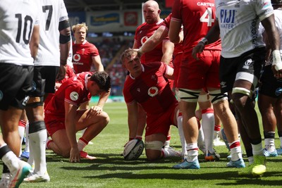 040726 - Fiji v Wales - Nations Championship - Jac Morgan of Wales is helped over by team mates to score a try 