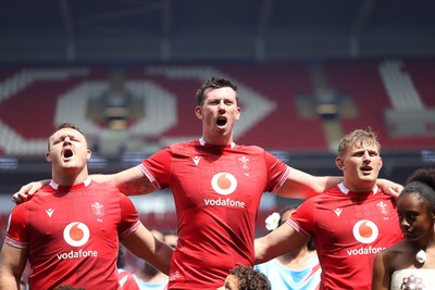 040726 - Fiji v Wales - Nations Championship - Dewi Lake, Adam Beard and Jac Morgan of Wales sing the anthem