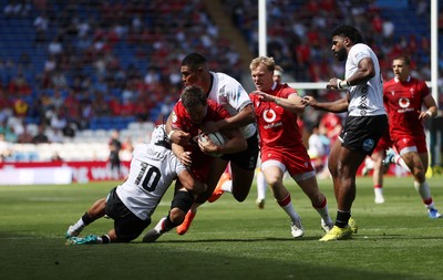 040726 - Fiji v Wales - Nations Championship - Alex Mann of Wales is tackled by Isaiah Armstrong-Ravula of Fiji 