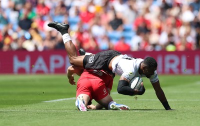 040726 - Fiji v Wales, Nations Championship - Jiuta Wainiqolo of Fiji is tackled by Tomos Williams of Wales