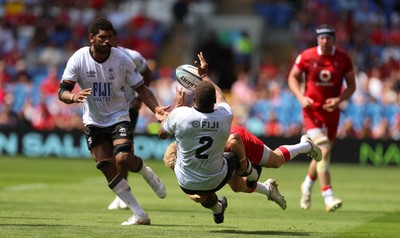 040726 - Fiji v Wales, Nations Championship - Tevita Ikanivere of Fiji offloads as he is tackled by Blair Murray of Wales