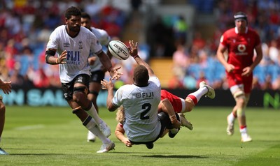 040726 - Fiji v Wales, Nations Championship - Tevita Ikanivere of Fiji offloads as he is tackled by Blair Murray of Wales