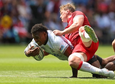 040726 - Fiji v Wales, Nations Championship - Elia Canakaivata of Fiji is tackled by Jac Morgan of Wales