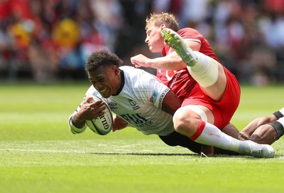 040726 - Fiji v Wales, Nations Championship - Elia Canakaivata of Fiji is tackled by Jac Morgan of Wales