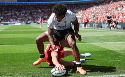 040726 - Fiji v Wales, Nations Championship - Josh Adams of Wales reaches between the legs of Selestino Ravutaumada of Fiji to score try
