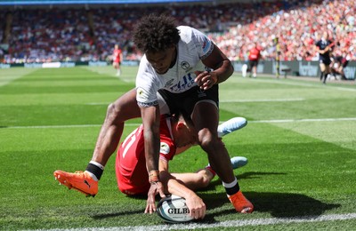 040726 - Fiji v Wales, Nations Championship - Josh Adams of Wales reaches between the legs of Selestino Ravutaumada of Fiji to score try