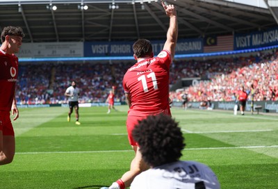 040726 - Fiji v Wales, Nations Championship - Josh Adams of Wales reaches between the legs of Selestino Ravutaumada of Fiji to score try