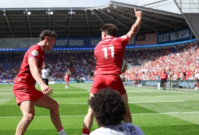 040726 - Fiji v Wales, Nations Championship - Josh Adams of Wales reaches between the legs of Selestino Ravutaumada of Fiji to score try
