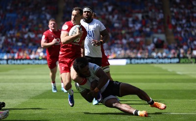 040726 - Fiji v Wales, Nations Championship - Tomos Williams of Wales is tackled just short of the line