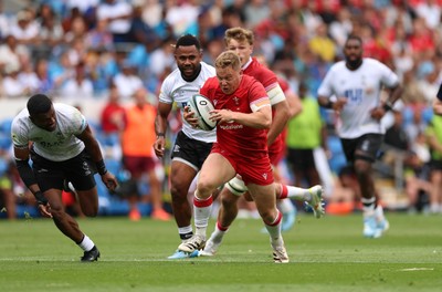 040726 - Fiji v Wales, Nations Championship - Sam Costelow of Wales breaks away