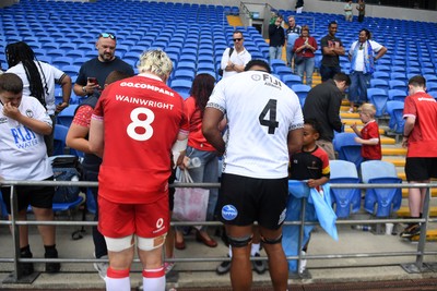 040726 - Fiji v Wales - Nations Championship - Aaron Wainwright of Wales and Isoa Nasilasila of Fiji with fans at full time