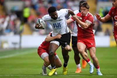 040726 - Fiji v Wales - Nations Championship - Kalaveti Ravouvou of Fiji is challenged by Josh Adams of Wales