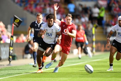 040726 - Fiji v Wales - Nations Championship - Josh Adams of Wales is challenged by Selestino Ravutaumada of Fiji