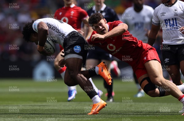 040726 - Fiji v Wales - Nations Championship - Isaiah Armstrong-Ravula of Fiji is tackled by Eddie James of Wales 