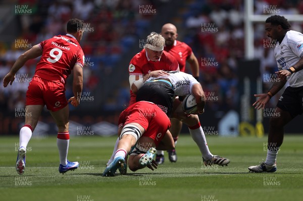 040726 - Fiji v Wales - Nations Championship - Isaiah Armstrong-Ravula of Fiji is tackled by Aaron Wainwright of Wales 