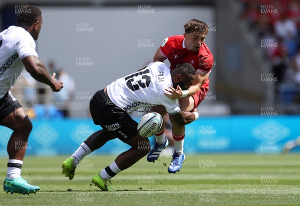 040726 - Fiji v Wales - Nations Championship - Dan Edwards of Wales is tackled by Semi Radradra of Fiji 