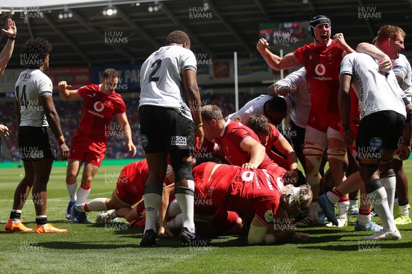040726 - Fiji v Wales - Nations Championship - Jac Morgan of Wales is helped over by team mates to score a try 