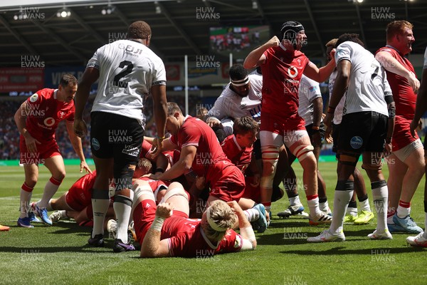 040726 - Fiji v Wales - Nations Championship - Jac Morgan of Wales is helped over by team mates to score a try 