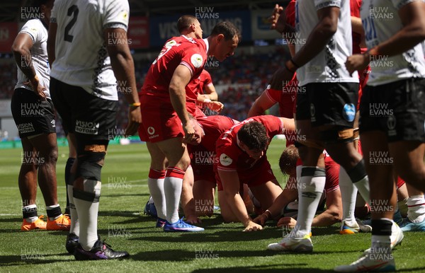 040726 - Fiji v Wales - Nations Championship - Jac Morgan of Wales is helped over by team mates to score a try 