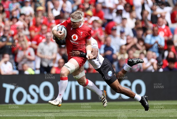 040726 - Fiji v Wales - Nations Championship - Aaron Wainwright of Wales is tackled by Jiuta Wainiqolo of Fiji 