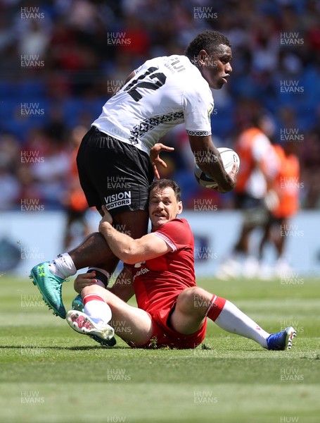 040726 - Fiji v Wales - Nations Championship - Josua Tuisova of Fiji is tackled by Tomos Williams of Wales 