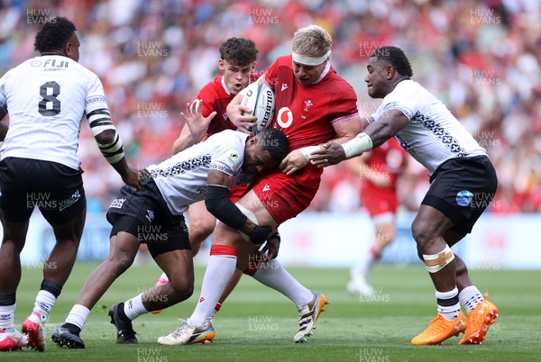 040726 - Fiji v Wales - Nations Championship - Aaron Wainwright of Wales is tackled by Jiuta Wainiqolo of Fiji 
