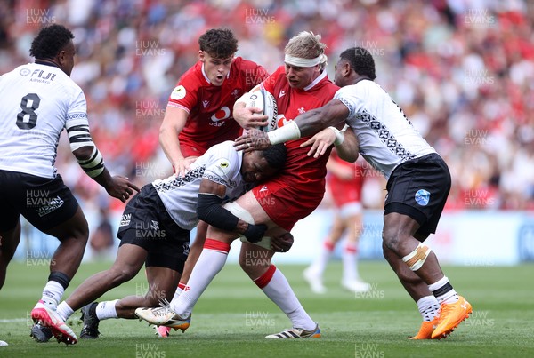 040726 - Fiji v Wales - Nations Championship - Aaron Wainwright of Wales is tackled by Jiuta Wainiqolo of Fiji 
