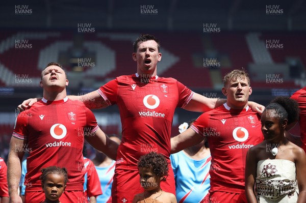 040726 - Fiji v Wales - Nations Championship - Dewi Lake, Adam Beard and Jac Morgan of Wales sing the anthem
