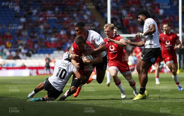 040726 - Fiji v Wales - Nations Championship - Alex Mann of Wales is tackled by Isaiah Armstrong-Ravula of Fiji 