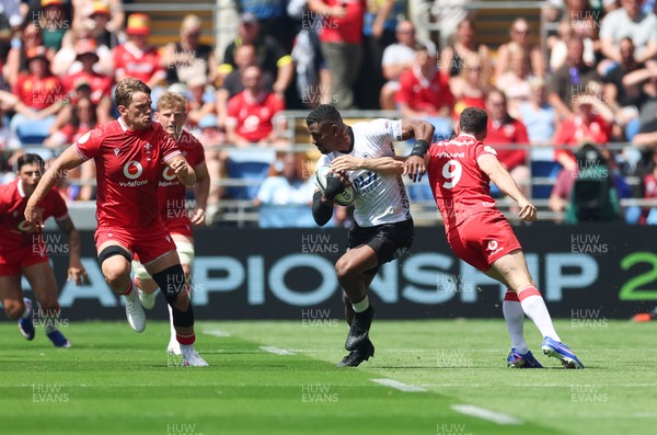 040726 - Fiji v Wales, Nations Championship - Jiuta Wainiqolo of Fiji takes on Tomos Williams of Wales
