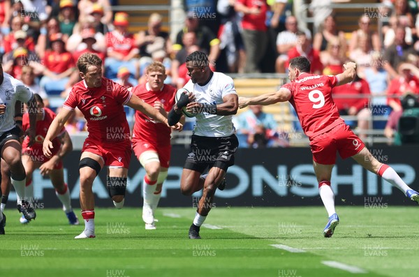 040726 - Fiji v Wales, Nations Championship - Jiuta Wainiqolo of Fiji takes on Tomos Williams of Wales