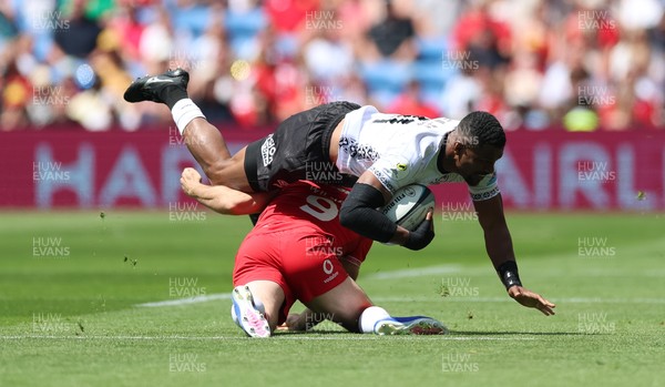 040726 - Fiji v Wales, Nations Championship - Jiuta Wainiqolo of Fiji is tackled by Tomos Williams of Wales