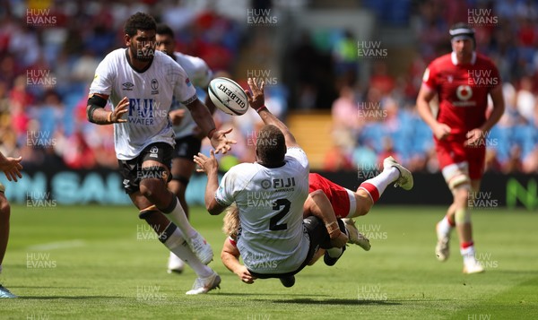 040726 - Fiji v Wales, Nations Championship - Tevita Ikanivere of Fiji offloads as he is tackled by Blair Murray of Wales
